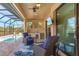 Inviting covered lanai with comfortable seating, outdoor kitchen, and a view of the sparkling pool at 16211 Cayman Ln, Punta Gorda, FL 33955