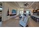 Spacious living room with tile floors, ceiling fan, and seamless flow to other living areas at 16211 Cayman Ln, Punta Gorda, FL 33955