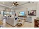 Inviting living room features neutral tones, tile floors, and sliding doors to screened patio at 16211 Cayman Ln, Punta Gorda, FL 33955