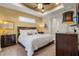 Bright main bedroom features neutral paint, tray ceiling, and traditional-style furnishings at 16211 Cayman Ln, Punta Gorda, FL 33955