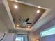 This main bedroom features tray ceiling, ceiling fan, recessed lights and exterior views at 16211 Cayman Ln, Punta Gorda, FL 33955