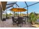 Comfortable outdoor seating area with grill, perfect for alfresco dining and enjoying the water view at 16211 Cayman Ln, Punta Gorda, FL 33955