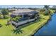 An exterior view of an enclosed pool behind a waterfront house at 16211 Cayman Ln, Punta Gorda, FL 33955