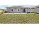 Spacious backyard featuring a patio, healthy lawn, and lush green grass at 16621 Sunburst Lake St, Wimauma, FL 33598