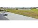 View of backyard with pond and manicured lawn at 16621 Sunburst Lake St, Wimauma, FL 33598