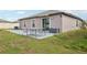 View of backyard showing patio, good sized-lawn and external storage at 16621 Sunburst Lake St, Wimauma, FL 33598