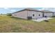 Back exterior view showing well maintained lawn, landscaping, and patio at 16621 Sunburst Lake St, Wimauma, FL 33598