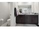 Bathroom featuring a dual sink vanity, granite countertop and modern fixtures at 16621 Sunburst Lake St, Wimauma, FL 33598