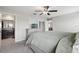 Bright, spacious main bedroom featuring a ceiling fan, and carpeted floors at 16621 Sunburst Lake St, Wimauma, FL 33598