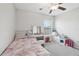 Bright bedroom with a ceiling fan, vanity, and window offering plenty of natural light at 16621 Sunburst Lake St, Wimauma, FL 33598