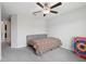 Bright bedroom with a ceiling fan, neutral walls, and ample space for relaxation and activities at 16621 Sunburst Lake St, Wimauma, FL 33598