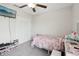 Cozy bedroom featuring a ceiling fan, closet, and a mounted TV for added entertainment at 16621 Sunburst Lake St, Wimauma, FL 33598