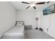 Inviting bedroom with a ceiling fan, mounted TV, and basketball hoop for recreation at 16621 Sunburst Lake St, Wimauma, FL 33598