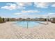Scenic view of the community pool featuring a zero entry access point and surrounding neighborhood at 16621 Sunburst Lake St, Wimauma, FL 33598