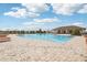 Expansive community pool with a clubhouse and lounge chairs, ideal for summer enjoyment at 16621 Sunburst Lake St, Wimauma, FL 33598