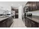 A view of the kitchen, highlighting stainless steel appliances and granite countertops at 16621 Sunburst Lake St, Wimauma, FL 33598