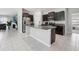 Open kitchen with stainless steel appliances, granite countertops, and dark wood cabinetry at 16621 Sunburst Lake St, Wimauma, FL 33598