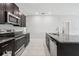 A modern kitchen with granite countertops and stainless steel appliances at 16621 Sunburst Lake St, Wimauma, FL 33598