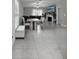 Bright, open-plan living room featuring tile floors, modern furnishings, and ample natural light at 16621 Sunburst Lake St, Wimauma, FL 33598