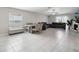 Bright, open-plan living room featuring tile floors, modern furnishings, and ample natural light at 16621 Sunburst Lake St, Wimauma, FL 33598