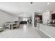 Bright, open-concept living space featuring a modern kitchen, dining area, and cozy living room at 16621 Sunburst Lake St, Wimauma, FL 33598