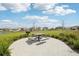 Charming picnic area with a grill and table, set amidst lush landscaping and scenic views at 16621 Sunburst Lake St, Wimauma, FL 33598