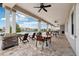 Inviting pool patio with ceiling fans, tables, chairs and outdoor living space at 16621 Sunburst Lake St, Wimauma, FL 33598