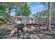 Inviting backyard featuring a grill, fire pit, and multiple seating areas, perfect for entertaining at 1664 10Th St, Sarasota, FL 34236
