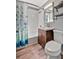 Bathroom features a modern vanity, a shower-tub combination with a stylish curtain at 1664 10Th St, Sarasota, FL 34236