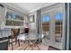 Dining area boasts a modern glass table with views of the outdoor patio through French doors at 1664 10Th St, Sarasota, FL 34236