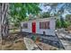 Adorable home with a red door, complemented by a cozy patio area perfect for outdoor relaxation at 1664 10Th St, Sarasota, FL 34236