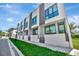 Modern townhome exterior featuring clean lines, large windows, and well-kept landscaping at 1664 10Th St, Sarasota, FL 34236
