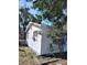 Exterior view of home with white vinyl siding, red window trim, and mature landscaping at 1664 10Th St, Sarasota, FL 34236