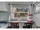 Kitchen nook includes a built in table looking out a window at 1664 10Th St, Sarasota, FL 34236