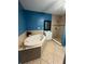 Bathroom featuring a standalone tub, walk-in shower, and tiled flooring at 1807 48Th W Ave, Bradenton, FL 34207