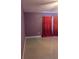 Bedroom with purple walls, tile floors, and window with red curtains at 1807 48Th W Ave, Bradenton, FL 34207