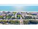 Wonderful aerial view showcases the beachfront condo, parking, and tropical landscape at 1945 Gulf Of Mexico Dr # M2-110, Longboat Key, FL 34228