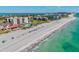 Aerial shot of the condo complex highlighting the beach, ocean, and well-manicured landscaping at 1945 Gulf Of Mexico Dr # M2-110, Longboat Key, FL 34228