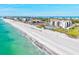 An aerial image captures the condo complex and the shoreline that stretches along the scenic beach at 1945 Gulf Of Mexico Dr # M2-110, Longboat Key, FL 34228
