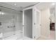 Bathroom features a bathtub-shower with glass doors, safety bar and a separate sliding door for privacy at 1945 Gulf Of Mexico Dr # M2-110, Longboat Key, FL 34228
