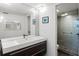 Modern bathroom with sleek vanity, stylish mirror, and glass-enclosed shower at 1945 Gulf Of Mexico Dr # M2-110, Longboat Key, FL 34228