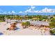 Aerial view of a beachfront dining area, lifeguard tower and sandy beach at 1945 Gulf Of Mexico Dr # M2-110, Longboat Key, FL 34228
