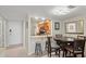 Cozy dining area adjacent to the kitchen featuring bar seating, a round table, and ample lighting at 1945 Gulf Of Mexico Dr # M2-110, Longboat Key, FL 34228