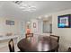 Cozy dining room with modern lighting, bar access to kitchen, and ocean views at 1945 Gulf Of Mexico Dr # 110, Longboat Key, FL 34228