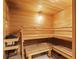 Inviting sauna with wooden benches, heater, and tiled floor, providing a relaxing experience at 1945 Gulf Of Mexico Dr # M2-110, Longboat Key, FL 34228