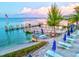 A charming waterfront area with picnic tables and umbrellas near a scenic pier at 1945 Gulf Of Mexico Dr # M2-110, Longboat Key, FL 34228