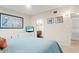 A bright bedroom featuring a comfy bed, modern dresser, and stylish wall art at 1945 Gulf Of Mexico Dr # M2-110, Longboat Key, FL 34228