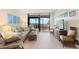 Inviting living room with ocean views, comfortable furnishings, and access to a private balcony at 1945 Gulf Of Mexico Dr # M2-110, Longboat Key, FL 34228