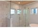 Bright bathroom features tiled walls, pebble floor in the glass shower, and a wood plank ceiling at 206 23Rd W St, Bradenton, FL 34205
