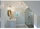 Bathroom featuring glass enclosed shower, single vanity, and decorative mirror at 206 23Rd W St, Bradenton, FL 34205